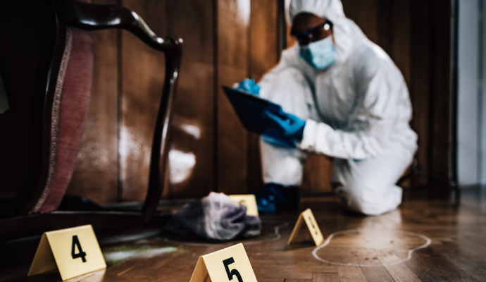 Professional wearing safety outfit cleaning biohazard.