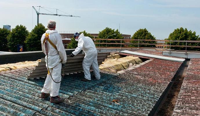 a couple of professionals removing asbestos