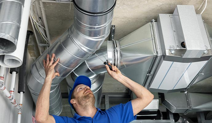 professional worker cleaning duct pipe