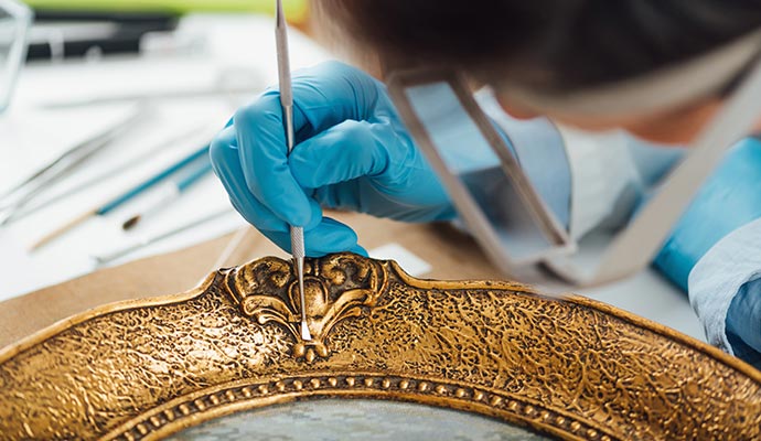 Person restoring an antique object