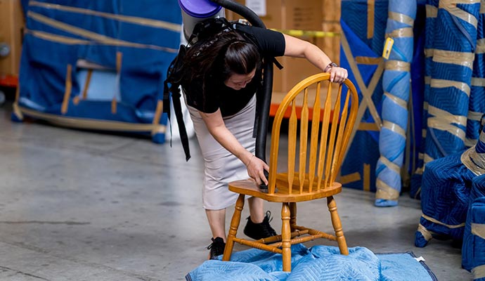 a professional fixing a wooden chair