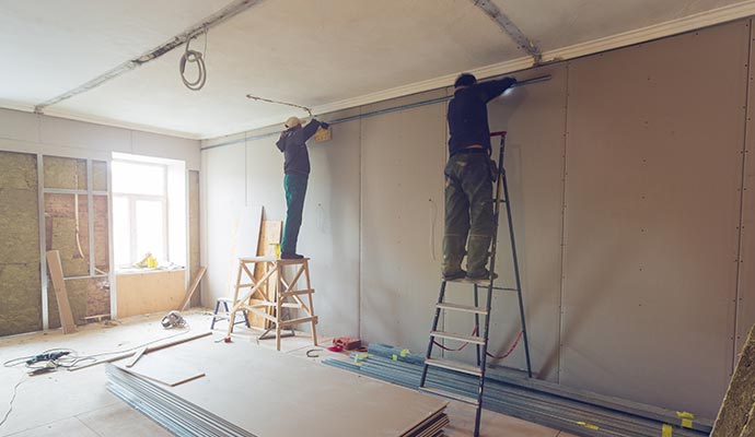 A couple of professionals reconstructing damaged property