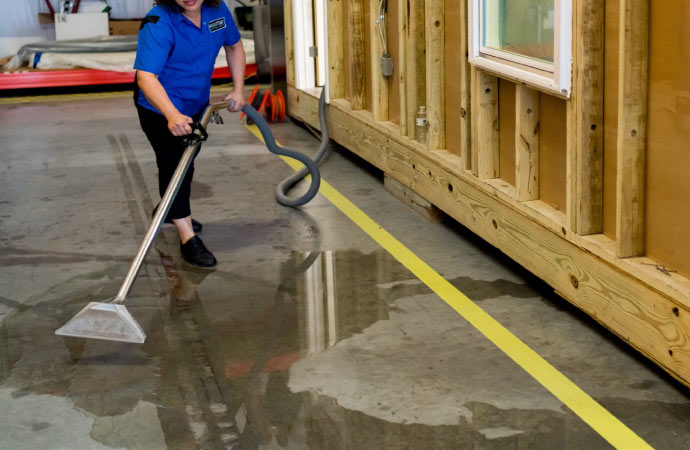 a professional cleaning water from the floor