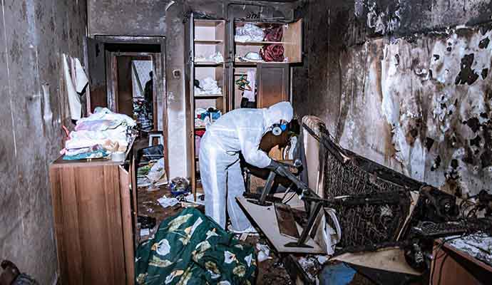 Expert restoring fire damaged house.