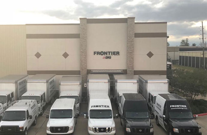 Frontier vehicles in front of their office