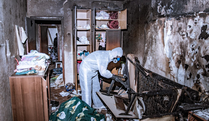 professional worker restoring a fire damaged house