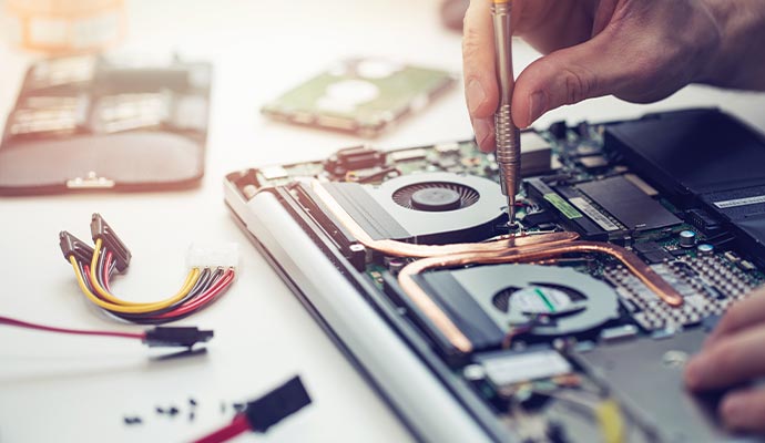 Expert repairing laptop computer.