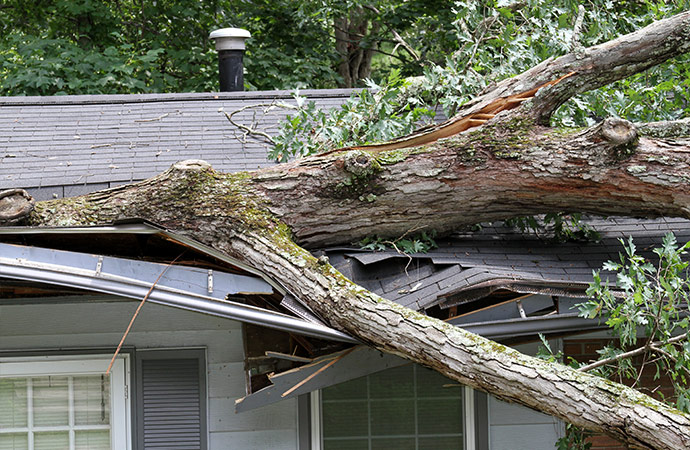 a house roof damaged by the aftermath of a storm