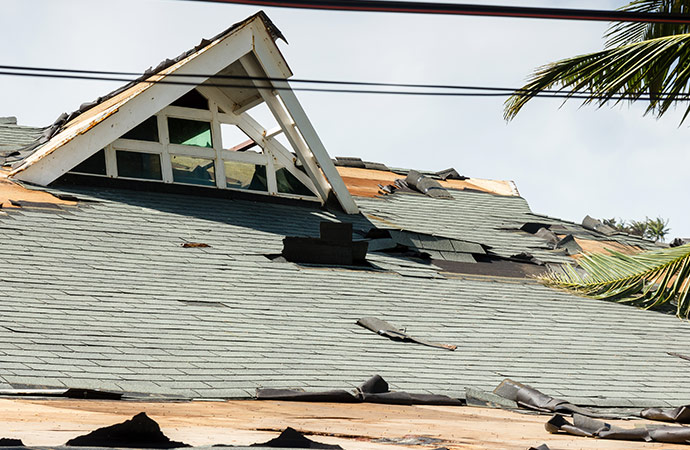 a roof damaged by the wind of a storm