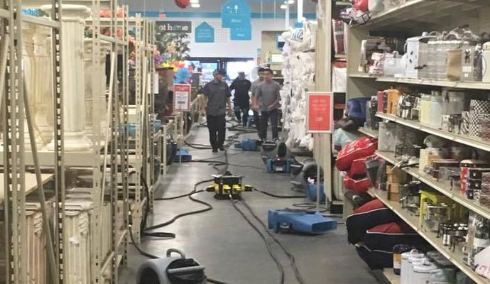 Team restoring water damaged retail store