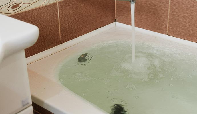 a shower tub overflowing with water