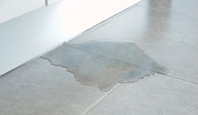 Water leaking onto a tiled floor